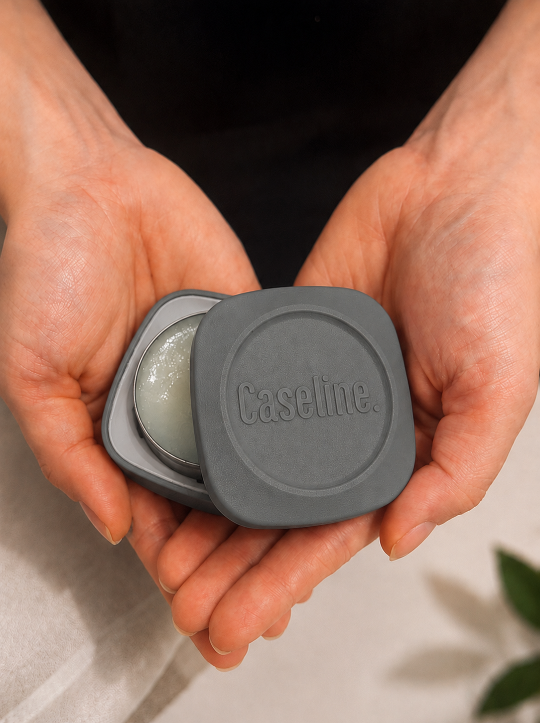 Caseline grey case half open in a persons hands