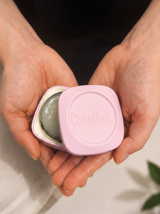 Caseline pink case half open in a persons hands